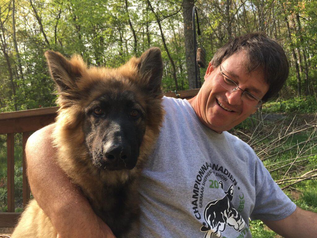 Picture of John P Jones, dog trainer, with a German Shephard